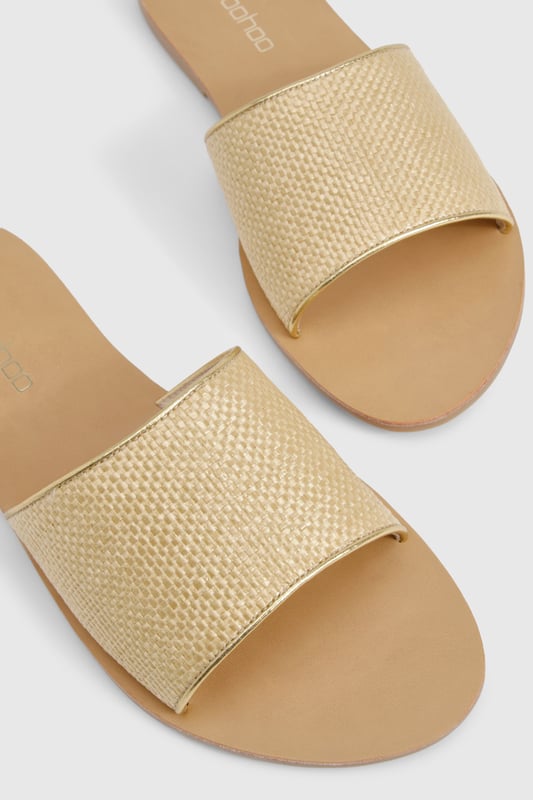 Raffia Mule Sandal Textured bast-style slide sandals with a single wide strap design
Flat heel measuring between 0-2cm for all-day comfort
Open toe silhouette perfect for showcasing pedicures
Slip-on style for effortless wear
Versatile neutral tone that complements any summer outfit
These minimalist bast-style sandals from Boohoo combine simplicity with versatility for your warm-weather wardrobe. The understated design features a comfortable flat sole that's ideal for city exploring or beachside strolls. Style them with cropped linen trousers and an oversized shirt for casual daytime outings, or pair with a flowing maxi dress for family gatherings and garden parties. The neutral tone works brilliantly with bold prints and patterns, making these sandals a true wardrobe staple. For festival season, match them with denim shorts and a graphic tee, adding layered jewellery for a touch of bohemian flair. Their lightweight construction makes them perfect for packing in your holiday suitcase, whilst the durable sole ensures they'll remain a favourite throughout the summer months.