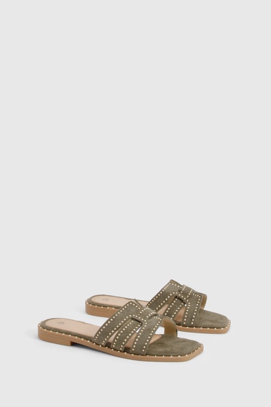 Cut Out Studded Strap Slider Flat Sandals Striking cut-out design with decorative studded straps for a contemporary edge
Flat sole with subtle stitch detailing around the edge for added durability
Open-toe silhouette offering maximum comfort during warmer days
Slip-on style for effortless wear and convenience
Versatile neutral tone that complements a variety of outfits
These chic cut-out sandals combine style and practicality for your everyday summer wardrobe. The distinctive studded straps create visual interest while maintaining a relaxed aesthetic that's perfect for casual outings. Style them with a flowing midi dress and woven bag for farmers' markets and weekend brunches, or pair with cropped linen trousers and a simple tee for shopping trips and coffee dates. The flat design ensures all-day comfort without compromising on style, making these sandals ideal for city breaks where extensive walking is required. For beach holidays, wear them with denim shorts and an oversized shirt as a stylish alternative to flip-flops. Their versatile design transitions seamlessly from daytime casual to relaxed evening gatherings, offering excellent value for your summer footwear collection.