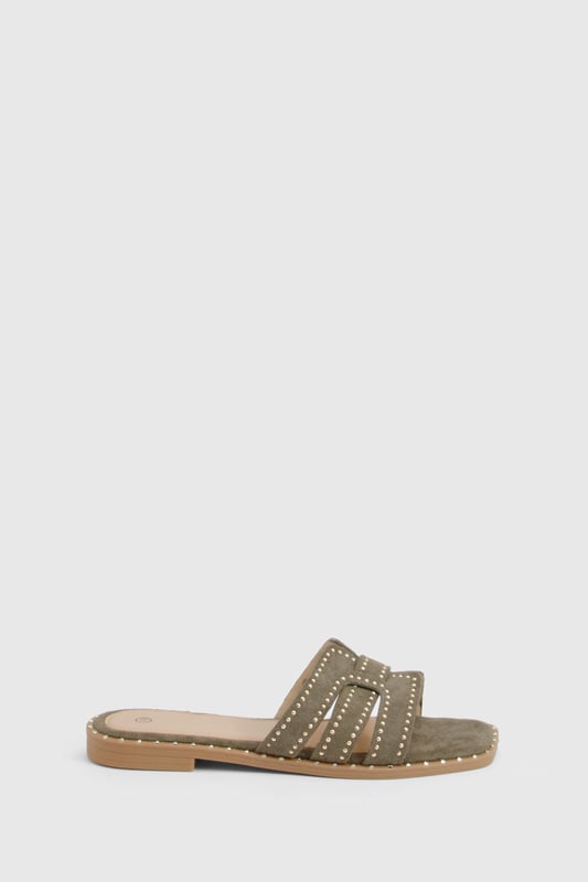 Cut Out Studded Strap Slider Flat Sandals Striking cut-out design with decorative studded straps for a contemporary edge
Flat sole with subtle stitch detailing around the edge for added durability
Open-toe silhouette offering maximum comfort during warmer days
Slip-on style for effortless wear and convenience
Versatile neutral tone that complements a variety of outfits
These chic cut-out sandals combine style and practicality for your everyday summer wardrobe. The distinctive studded straps create visual interest while maintaining a relaxed aesthetic that's perfect for casual outings. Style them with a flowing midi dress and woven bag for farmers' markets and weekend brunches, or pair with cropped linen trousers and a simple tee for shopping trips and coffee dates. The flat design ensures all-day comfort without compromising on style, making these sandals ideal for city breaks where extensive walking is required. For beach holidays, wear them with denim shorts and an oversized shirt as a stylish alternative to flip-flops. Their versatile design transitions seamlessly from daytime casual to relaxed evening gatherings, offering excellent value for your summer footwear collection.