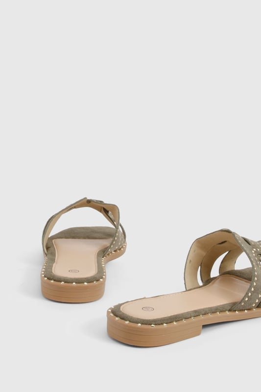 Cut Out Studded Strap Slider Flat Sandals Striking cut-out design with decorative studded straps for a contemporary edge
Flat sole with subtle stitch detailing around the edge for added durability
Open-toe silhouette offering maximum comfort during warmer days
Slip-on style for effortless wear and convenience
Versatile neutral tone that complements a variety of outfits
These chic cut-out sandals combine style and practicality for your everyday summer wardrobe. The distinctive studded straps create visual interest while maintaining a relaxed aesthetic that's perfect for casual outings. Style them with a flowing midi dress and woven bag for farmers' markets and weekend brunches, or pair with cropped linen trousers and a simple tee for shopping trips and coffee dates. The flat design ensures all-day comfort without compromising on style, making these sandals ideal for city breaks where extensive walking is required. For beach holidays, wear them with denim shorts and an oversized shirt as a stylish alternative to flip-flops. Their versatile design transitions seamlessly from daytime casual to relaxed evening gatherings, offering excellent value for your summer footwear collection.
