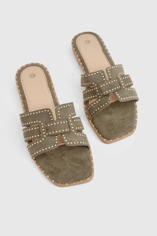 Cut Out Studded Strap Slider Flat Sandals Striking cut-out design with decorative studded straps for a contemporary edge
Flat sole with subtle stitch detailing around the edge for added durability
Open-toe silhouette offering maximum comfort during warmer days
Slip-on style for effortless wear and convenience
Versatile neutral tone that complements a variety of outfits
These chic cut-out sandals combine style and practicality for your everyday summer wardrobe. The distinctive studded straps create visual interest while maintaining a relaxed aesthetic that's perfect for casual outings. Style them with a flowing midi dress and woven bag for farmers' markets and weekend brunches, or pair with cropped linen trousers and a simple tee for shopping trips and coffee dates. The flat design ensures all-day comfort without compromising on style, making these sandals ideal for city breaks where extensive walking is required. For beach holidays, wear them with denim shorts and an oversized shirt as a stylish alternative to flip-flops. Their versatile design transitions seamlessly from daytime casual to relaxed evening gatherings, offering excellent value for your summer footwear collection.