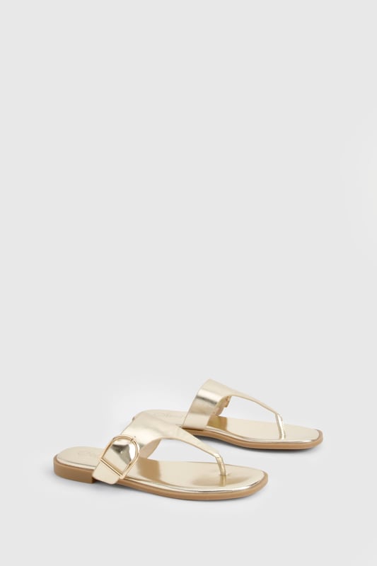 Stylish flip-flops featuring an eye-catching buckle detail for added interest
        Flat heel design (under 2cm) ensures all-day comfort without compromising on style
        Toe-post silhouette with a sleek strap across the foot for secure wear
        Metallic finish adds a touch of glamour to casual outfits
        Lightweight construction makes these perfect for holiday packing or summer days
    
    These chic flip-flops with distinctive buckle detailing offer the perfect blend of comfort and style for your summer wardrobe. The flat design ensures you can wear them all day without discomfort, whilst the metallic finish adds a touch of sophistication to even the most casual ensemble. Pair with flowing maxi dresses and oversized sunglasses for beach days, or team with cropped jeans and a simple tee for weekend brunches. The versatile design makes these sandals ideal for garden parties, casual shopping trips, or holiday sightseeing. Their slip-on style offers effortless convenience, whilst the decorative buckle provides a fashionable focal point that sets them apart from ordinary flip-flops. A true summer essential that works seamlessly from poolside to pavement, these sandals will quickly become your go-to footwear for the warmer months.