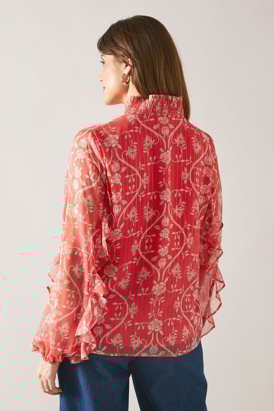 Floral Metallic Ruffle Blouse Elegant V-neckline with delicate tie detail for adjustable styling
Feminine ruffle detailing along the front and sleeves for a sophisticated touch
Lightweight viscose fabric offering comfort and graceful drape
Striking floral pattern that adds visual interest to any ensemble
Long sleeves with subtle volume for a flattering silhouette
This charming Wallis blouse combines sophistication with effortless style. The delicate ruffle detailing creates movement and dimension, whilst the V-neckline with tie feature allows for customisable styling. Perfect for daytime occasions, pair with wide-leg denim trousers and leather sandals for family gatherings or weekend brunches. For a more polished daywear look, tuck into tailored trousers and add a structured tote bag. The lightweight viscose fabric ensures comfort throughout the day, making this blouse ideal for transitional weather. The distinctive floral pattern works beautifully with neutral accessories, allowing the blouse to be the focal point of your outfit. Style with simple gold-toned jewellery to complement the feminine aesthetic of this versatile piece.