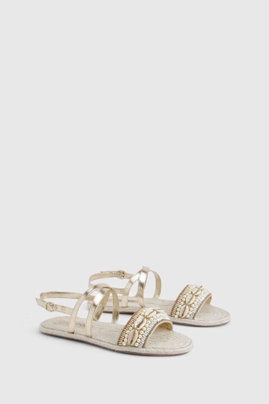 Wide fit espadrilles with eye-catching sequin embellishment across the front strap
        Comfortable flat heel measuring between 0-2cm for all-day wear
        Adjustable ankle strap with buckle fastening for a secure fit
        Traditional rope-style sole adds authentic espadrille character
        Metallic straps create a versatile, statement finish perfect for summer styling
    
    These wide fit espadrilles blend comfort with captivating style, making them the perfect companion for your summer wardrobe. The sequin-detailed front strap catches the light beautifully, whilst the metallic straps add a touch of glamour to casual outfits. Style with a flowing maxi dress and straw hat for beachside strolls, or pair with cropped linen trousers and a simple tee for weekend brunches. The adjustable ankle strap ensures these sandals stay securely in place, whilst the traditional espadrille base provides that quintessential holiday feel. Ideal for family gatherings, city explorations or garden parties, these versatile flats offer both comfort and style without compromising on either. The wide fit design ensures all-day comfort, making these the sandals you'll reach for throughout the warmer months.