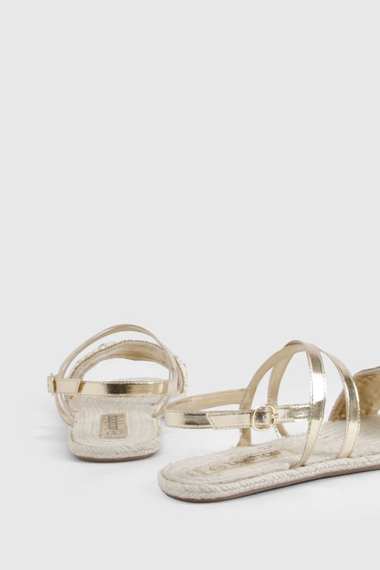 Wide fit espadrilles with eye-catching sequin embellishment across the front strap
        Comfortable flat heel measuring between 0-2cm for all-day wear
        Adjustable ankle strap with buckle fastening for a secure fit
        Traditional rope-style sole adds authentic espadrille character
        Metallic straps create a versatile, statement finish perfect for summer styling
    
    These wide fit espadrilles blend comfort with captivating style, making them the perfect companion for your summer wardrobe. The sequin-detailed front strap catches the light beautifully, whilst the metallic straps add a touch of glamour to casual outfits. Style with a flowing maxi dress and straw hat for beachside strolls, or pair with cropped linen trousers and a simple tee for weekend brunches. The adjustable ankle strap ensures these sandals stay securely in place, whilst the traditional espadrille base provides that quintessential holiday feel. Ideal for family gatherings, city explorations or garden parties, these versatile flats offer both comfort and style without compromising on either. The wide fit design ensures all-day comfort, making these the sandals you'll reach for throughout the warmer months.