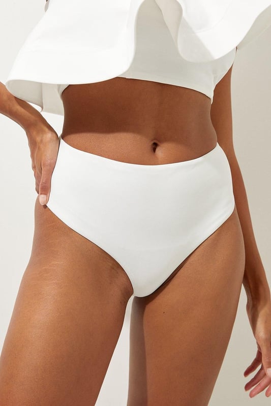 High Waist Bikini Bottom Welcome the sun with a bikini that will turn heads, the bottoms of which feature an ultra flattering high waisted design, and a high leg cut to elongate the legs. Style this piece with the matching top, as well as strappy sandals and a beach cover up for a holiday look that can be reworn time and time again. High Waist Bikini Bottom Cheeky Cut High Leg Design Flattering High Waisted Design Matching Top Sold Separately