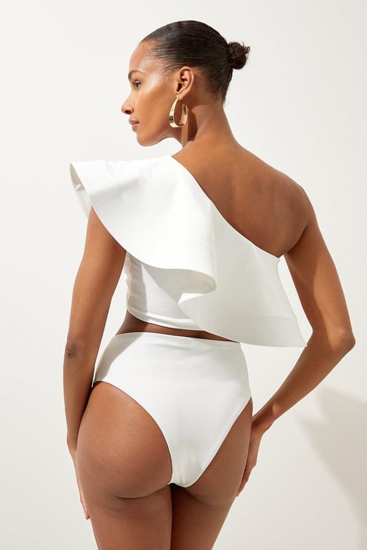High Waist Bikini Bottom Welcome the sun with a bikini that will turn heads, the bottoms of which feature an ultra flattering high waisted design, and a high leg cut to elongate the legs. Style this piece with the matching top, as well as strappy sandals and a beach cover up for a holiday look that can be reworn time and time again. High Waist Bikini Bottom Cheeky Cut High Leg Design Flattering High Waisted Design Matching Top Sold Separately