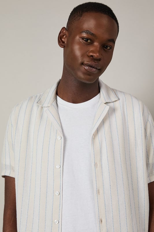 Textured stripe pattern adds subtle dimension to this classic short sleeve shirt
        Revere collar design offers a relaxed, open neckline perfect for warmer days
        Button-through front with clean finishing for effortless style
        Relaxed fit through the body provides comfortable all-day wear
        Versatile woven fabric with textural interest that maintains its shape throughout the day
    
    This Burton textured stripe shirt brings casual sophistication to your everyday wardrobe. The revere collar creates a laid-back yet put-together look that works brilliantly for various occasions. Style it as shown with dark trousers and a simple white t-shirt underneath for an effortless weekend ensemble, perfect for meeting mates at the pub or casual family gatherings. The textured stripe pattern adds character without overwhelming, making this shirt an excellent choice for summer barbecues or watching the match. For a smarter approach, pair with chinos and loafers. The versatile design transitions seamlessly from daytime casual to evening drinks, embodying Burton's commitment to practical yet stylish menswear that fits comfortably into the modern British man's lifestyle.