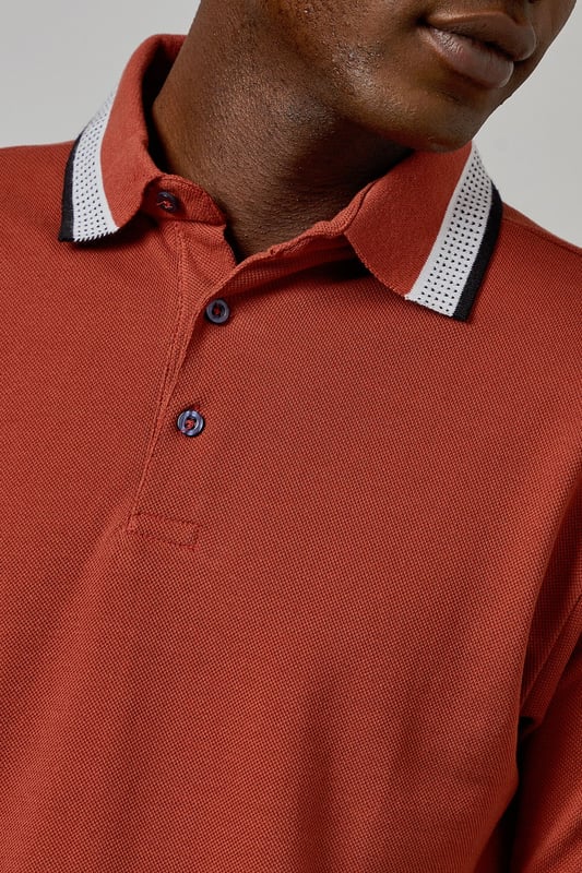 Distinctive jacquard collar with contrasting stripe detail
        Classic button placket with durable buttons for longevity
        Soft cotton fabric for all-day comfort
        Ribbed sleeve cuffs with matching trim for a refined finish
        Regular fit silhouette offering ease of movement
    
    This Burton polo shirt combines timeless style with contemporary detailing, making it a versatile addition to your casual wardrobe. The standout jacquard collar adds character to an otherwise classic design, while the cotton construction ensures breathability and comfort throughout the day. Style it as shown with neutral chinos and white trainers for an effortlessly smart-casual look perfect for weekend pub gatherings or family barbecues. For cooler evenings, layer under a lightweight bomber jacket or casual blazer. The versatile design transitions seamlessly from daytime outings to relaxed evening socials, offering the reliability and understated style that Burton is known for. Machine washable at 30 degrees, this polo maintains its shape and colour with proper care.