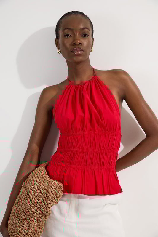 Shirred Cotton Tiered Halter Neck Woven Top This Karen Millen woven top combines casual charm with refined detailing, making it a versatile addition to your summer wardrobe. The shirred cotton construction offers both structure and comfort, while the halterneck design creates a feminine neckline that frames the decolletage beautifully. Style with crisp white trousers as shown for a fresh daytime look, or pair with tailored shorts and sandals for weekend brunches. The boxy fit works wonderfully with slim-fitting bottoms to create a balanced silhouette. Add a woven bag and delicate jewellery for family gatherings or casual outings. This piece transitions effortlessly from day to evening; simply swap your flats for block heels and add statement earrings for alfresco dining. Machine washable and easy to care for, this top delivers on both style and practicality. Crafted from pure cotton for breathable comfort throughout the day Distinctive halterneck design with tie fastening at the back for an adjustable fit Intricate shirring detail across the waist creates a flattering silhouette Tiered hem adds movement and dimension to this boxy-fit top Sleeveless style perfect for warmer weather with elegant shoulder-baring appeal