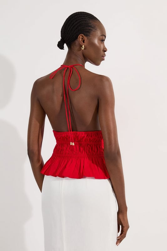 Shirred Cotton Tiered Halter Neck Woven Top This Karen Millen woven top combines casual charm with refined detailing, making it a versatile addition to your summer wardrobe. The shirred cotton construction offers both structure and comfort, while the halterneck design creates a feminine neckline that frames the decolletage beautifully. Style with crisp white trousers as shown for a fresh daytime look, or pair with tailored shorts and sandals for weekend brunches. The boxy fit works wonderfully with slim-fitting bottoms to create a balanced silhouette. Add a woven bag and delicate jewellery for family gatherings or casual outings. This piece transitions effortlessly from day to evening; simply swap your flats for block heels and add statement earrings for alfresco dining. Machine washable and easy to care for, this top delivers on both style and practicality. Crafted from pure cotton for breathable comfort throughout the day Distinctive halterneck design with tie fastening at the back for an adjustable fit Intricate shirring detail across the waist creates a flattering silhouette Tiered hem adds movement and dimension to this boxy-fit top Sleeveless style perfect for warmer weather with elegant shoulder-baring appeal