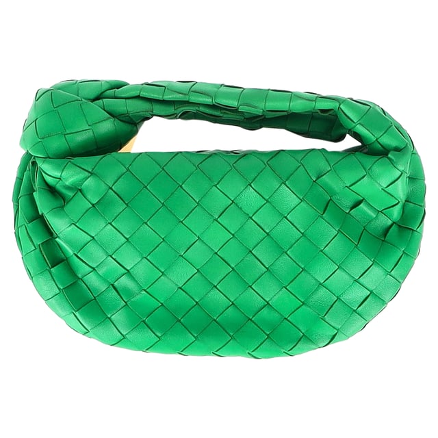 VINTAGE, RRP AS NEW
Elevate your accessory game with the Bottega Veneta Mini Jodie in Green Intrecciato Leather. This iconic bag is a true statement piece that exudes luxury and sophistication. The intricate woven leather detailing in a rich green hue adds a pop of artisanal elegance to any outfit. Whether paired with a casual daytime look or a chic evening ensemble, this mini bag is the epitome of refined style. Its compact size makes it perfect for carrying your essentials while maintaining an effortlessly elegant silhouette. Pair it with a neutral-toned tailored jumpsuit for a contemporary and polished look that seamlessly transitions from day to night.

Bottega Veneta Mini Jodie in Green Intrecciato Leather
Condition: Good
Signs of wear: Some black marks on exterior and interior surface
Packaging: Dust bag
Color: Green 
Material: Leather | leather
Size: One Size | One Size
Measurements: Width: 50; Height: 130; Length: 260; Handle drop: 50; Strap length: 0
SKU: NAPPUGBBA424692W