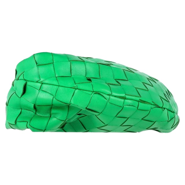 VINTAGE, RRP AS NEW
Elevate your accessory game with the Bottega Veneta Mini Jodie in Green Intrecciato Leather. This iconic bag is a true statement piece that exudes luxury and sophistication. The intricate woven leather detailing in a rich green hue adds a pop of artisanal elegance to any outfit. Whether paired with a casual daytime look or a chic evening ensemble, this mini bag is the epitome of refined style. Its compact size makes it perfect for carrying your essentials while maintaining an effortlessly elegant silhouette. Pair it with a neutral-toned tailored jumpsuit for a contemporary and polished look that seamlessly transitions from day to night.

Bottega Veneta Mini Jodie in Green Intrecciato Leather
Condition: Good
Signs of wear: Some black marks on exterior and interior surface
Packaging: Dust bag
Color: Green 
Material: Leather | leather
Size: One Size | One Size
Measurements: Width: 50; Height: 130; Length: 260; Handle drop: 50; Strap length: 0
SKU: NAPPUGBBA424692W