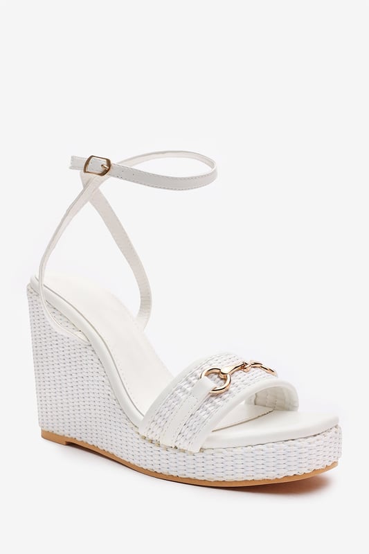 Wheres That From Womens 'Jenny' Wedge Heeled Sandals With Buckle Ankle Straps Elevate your warm-weather wardrobe with these Jenny Wedge Heeled Sandals With Buckle Ankle Straps. Designed with a raffia-style flatform heel and sleek ankle strap, they offer both stability and feminine flair. The gold-toned horse-bit detail adds a polished finish, making them perfect for garden parties, summer weddings, or casual chic days. Lightweight and stylish for all-day comfort. Key Features: • Material: Faux leather upper with woven raffia wedge base • Design: Open-toe wedge with gold detail and ankle strap • Closure: Adjustable ankle buckle for a secure fit