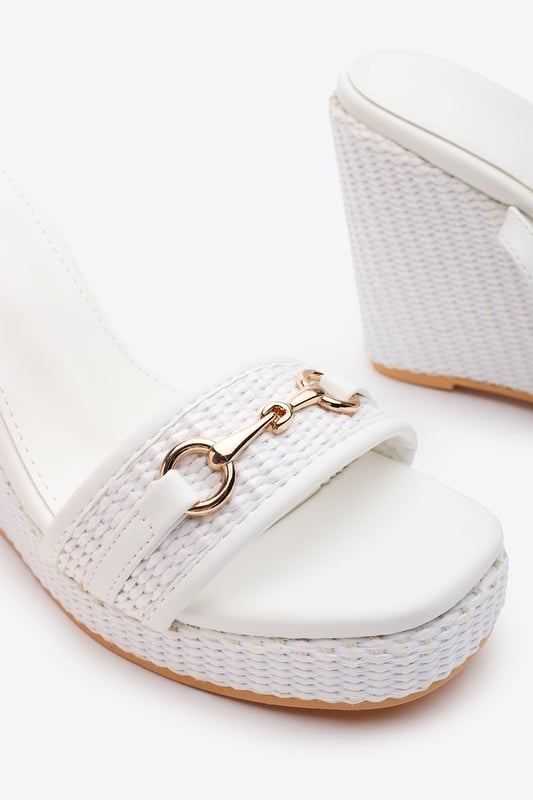 Wheres That From Womens 'Jenny' Wedge Heeled Sandals With Buckle Ankle Straps Elevate your warm-weather wardrobe with these Jenny Wedge Heeled Sandals With Buckle Ankle Straps. Designed with a raffia-style flatform heel and sleek ankle strap, they offer both stability and feminine flair. The gold-toned horse-bit detail adds a polished finish, making them perfect for garden parties, summer weddings, or casual chic days. Lightweight and stylish for all-day comfort. Key Features: • Material: Faux leather upper with woven raffia wedge base • Design: Open-toe wedge with gold detail and ankle strap • Closure: Adjustable ankle buckle for a secure fit