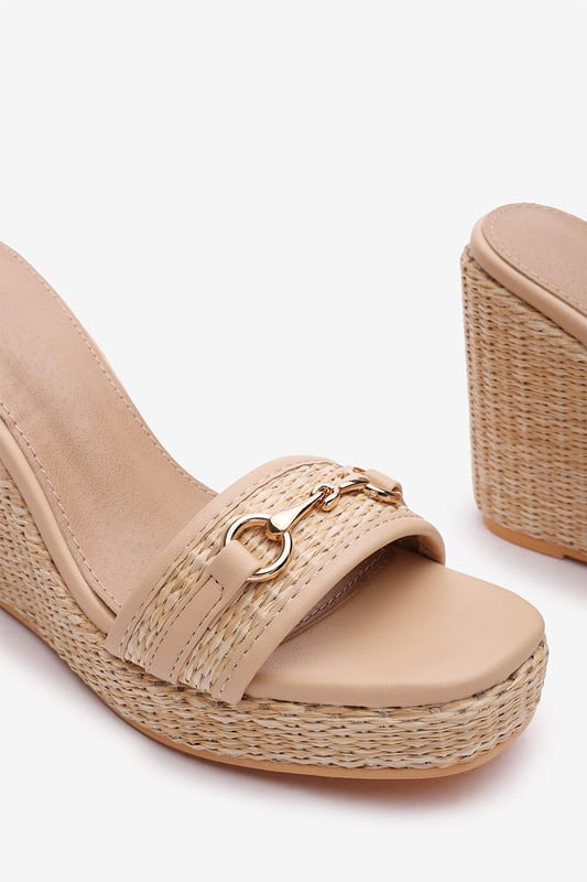 Wheres That From Womens 'Jenny' Wedge Heeled Sandals With Buckle Ankle Straps Elevate your warm-weather wardrobe with these Jenny Wedge Heeled Sandals With Buckle Ankle Straps. Designed with a raffia-style flatform heel and sleek ankle strap, they offer both stability and feminine flair. The gold-toned horse-bit detail adds a polished finish, making them perfect for garden parties, summer weddings, or casual chic days. Lightweight and stylish for all-day comfort. Key Features: • Material: Faux leather upper with woven raffia wedge base • Design: Open-toe wedge with gold detail and ankle strap • Closure: Adjustable ankle buckle for a secure fit