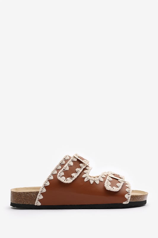 Wheres That From Womens 'Andi' Chunky Flatform Sandals With Cutout Straps Slide into effortless summer style with these Andi Chunky Flatform Sandals With Cutout Straps, crafted for comfort and standout design. Featuring bold contrast embroidery and dual adjustable buckle straps, they blend both charm with practicality. The cork-style footbed provides arch support, ideal for holidays, festivals, or casual city strolls. Key Features: • Material: Faux leather upper with a soft suede-effect footbed and cork midsole • Design: Dual-strap slide with decorative stitching and metallic buckles • Closure: Adjustable twin buckle straps for a secure and personalized fit