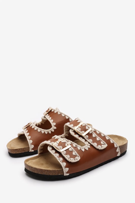 Wheres That From Womens 'Andi' Chunky Flatform Sandals With Cutout Straps Slide into effortless summer style with these Andi Chunky Flatform Sandals With Cutout Straps, crafted for comfort and standout design. Featuring bold contrast embroidery and dual adjustable buckle straps, they blend both charm with practicality. The cork-style footbed provides arch support, ideal for holidays, festivals, or casual city strolls. Key Features: • Material: Faux leather upper with a soft suede-effect footbed and cork midsole • Design: Dual-strap slide with decorative stitching and metallic buckles • Closure: Adjustable twin buckle straps for a secure and personalized fit