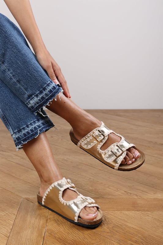 Wheres That From Womens 'Andi' Chunky Flatform Sandals With Cutout Straps Slide into effortless summer style with these Andi Chunky Flatform Sandals With Cutout Straps, crafted for comfort and standout design. Featuring bold contrast embroidery and dual adjustable buckle straps, they blend both charm with practicality. The cork-style footbed provides arch support, ideal for holidays, festivals, or casual city strolls. Key Features: • Material: Faux leather upper with a soft suede-effect footbed and cork midsole • Design: Dual-strap slide with decorative stitching and metallic buckles • Closure: Adjustable twin buckle straps for a secure and personalized fit