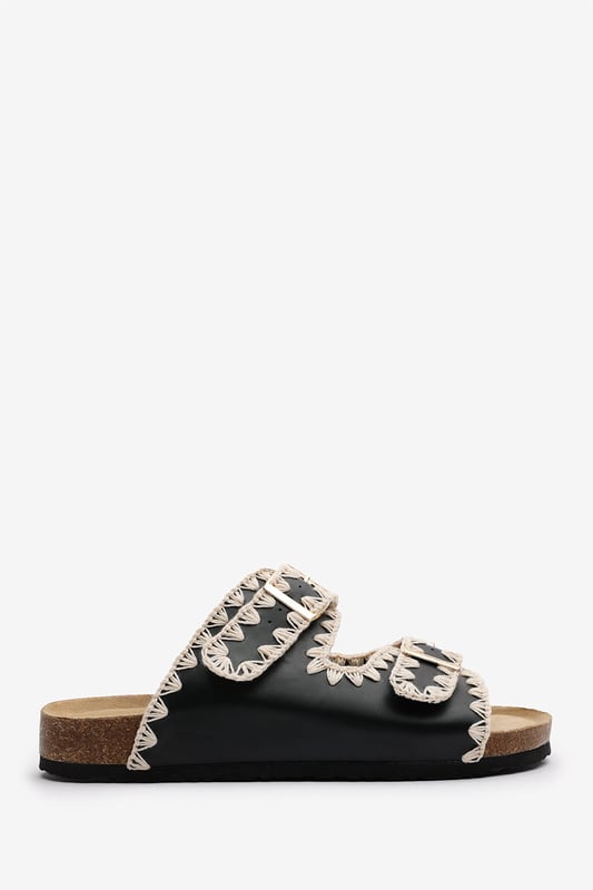 Slide into effortless summer style with these Andi Chunky Flatform Sandals With Cutout Straps, crafted for comfort and standout design. Featuring bold contrast embroidery and dual adjustable buckle straps, they blend both charm with practicality. The cork-style footbed provides arch support, ideal for holidays, festivals, or casual city strolls. Key Features: • Material: Faux leather upper with a soft suede-effect footbed and cork midsole • Design: Dual-strap slide with decorative stitching and metallic buckles • Closure: Adjustable twin buckle straps for a secure and personalized fit
