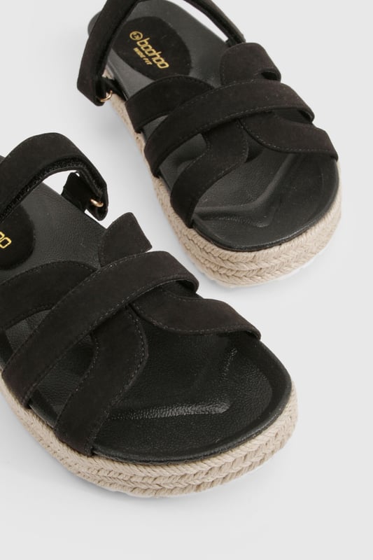 Wide Fit Faux Suede Cross Strap Flatform Sandals Wide fit design for all-day comfort and easy wear
Stylish cross-strap detailing adds visual interest to the upper
Flat platform with espadrille-style rope detailing around the sole
Slip-on style for effortless wearing
Heel height between 0-2cm, perfect for extended wear
These platform sandals combine contemporary style with practical comfort, making them an essential addition to your summer wardrobe. The cross-strap design creates a fashionable silhouette whilst the wide fit ensures they remain comfortable throughout the day. The espadrille-inspired platform sole adds a touch of Mediterranean flair to your look without sacrificing stability. Style these versatile sandals with flowing maxi dresses and oversized sunglasses for casual daytime outings, or pair with cropped linen trousers and a fitted tee for family gatherings. They transition seamlessly from beach days to city strolls, offering the perfect blend of fashion and function. The neutral design makes them incredibly adaptable, working beautifully with both bold patterns and understated ensembles for a range of casual occasions throughout the warmer months.