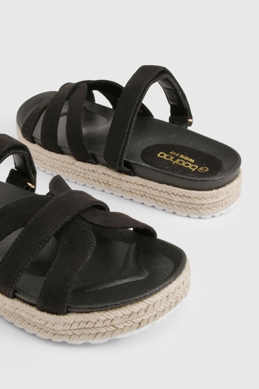 Wide Fit Faux Suede Cross Strap Flatform Sandals Wide fit design for all-day comfort and easy wear
Stylish cross-strap detailing adds visual interest to the upper
Flat platform with espadrille-style rope detailing around the sole
Slip-on style for effortless wearing
Heel height between 0-2cm, perfect for extended wear
These platform sandals combine contemporary style with practical comfort, making them an essential addition to your summer wardrobe. The cross-strap design creates a fashionable silhouette whilst the wide fit ensures they remain comfortable throughout the day. The espadrille-inspired platform sole adds a touch of Mediterranean flair to your look without sacrificing stability. Style these versatile sandals with flowing maxi dresses and oversized sunglasses for casual daytime outings, or pair with cropped linen trousers and a fitted tee for family gatherings. They transition seamlessly from beach days to city strolls, offering the perfect blend of fashion and function. The neutral design makes them incredibly adaptable, working beautifully with both bold patterns and understated ensembles for a range of casual occasions throughout the warmer months.