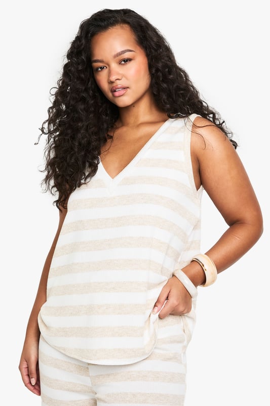 Sleeveless design for effortless warm-weather style
        V-neckline adds a flattering touch
        Striped pattern creates visual interest
        Relaxed fit for comfortable all-day wear
        Versatile piece suitable for various casual occasions
    
    Embrace laid-back chic with this striped knit top from Boohoo's plus-size collection. The sleeveless design and V-neckline combine to create a summery silhouette that's perfect for warm days and balmy evenings. The relaxed fit ensures comfort without compromising on style, making it an ideal choice for a range of casual events. Pair it with wide-leg trousers and sandals for a breezy look at family gatherings, or dress it up with a midi skirt and wedges for a casual dinner out. The versatile nature of this top allows for endless styling possibilities - layer it under a lightweight cardigan for cooler evenings or wear it solo with your favourite denim for a classic daytime ensemble. With its effortless appeal, this knit top is set to become a staple in your warm-weather wardrobe.