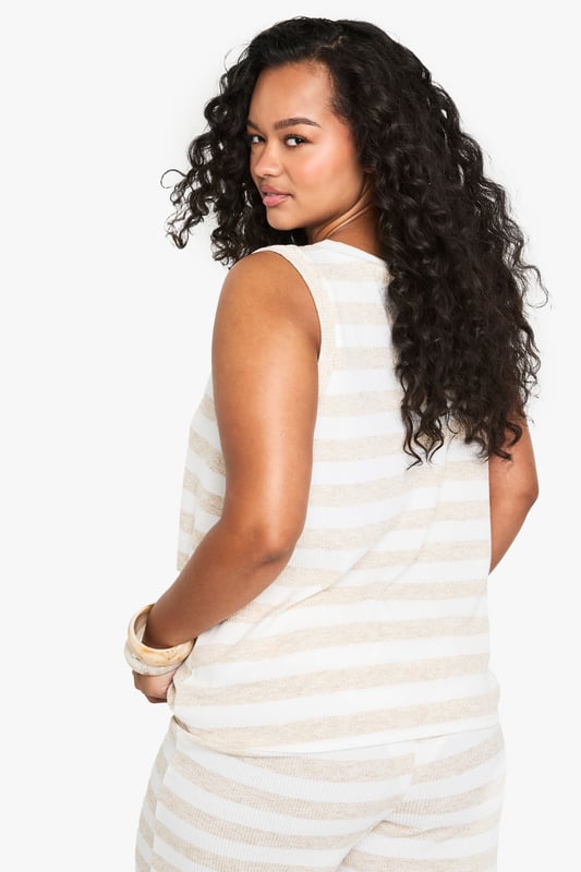 Sleeveless design for effortless warm-weather style
        V-neckline adds a flattering touch
        Striped pattern creates visual interest
        Relaxed fit for comfortable all-day wear
        Versatile piece suitable for various casual occasions
    
    Embrace laid-back chic with this striped knit top from Boohoo's plus-size collection. The sleeveless design and V-neckline combine to create a summery silhouette that's perfect for warm days and balmy evenings. The relaxed fit ensures comfort without compromising on style, making it an ideal choice for a range of casual events. Pair it with wide-leg trousers and sandals for a breezy look at family gatherings, or dress it up with a midi skirt and wedges for a casual dinner out. The versatile nature of this top allows for endless styling possibilities - layer it under a lightweight cardigan for cooler evenings or wear it solo with your favourite denim for a classic daytime ensemble. With its effortless appeal, this knit top is set to become a staple in your warm-weather wardrobe.