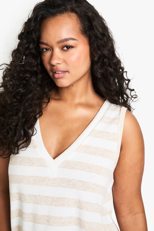 Sleeveless design for effortless warm-weather style
        V-neckline adds a flattering touch
        Striped pattern creates visual interest
        Relaxed fit for comfortable all-day wear
        Versatile piece suitable for various casual occasions
    
    Embrace laid-back chic with this striped knit top from Boohoo's plus-size collection. The sleeveless design and V-neckline combine to create a summery silhouette that's perfect for warm days and balmy evenings. The relaxed fit ensures comfort without compromising on style, making it an ideal choice for a range of casual events. Pair it with wide-leg trousers and sandals for a breezy look at family gatherings, or dress it up with a midi skirt and wedges for a casual dinner out. The versatile nature of this top allows for endless styling possibilities - layer it under a lightweight cardigan for cooler evenings or wear it solo with your favourite denim for a classic daytime ensemble. With its effortless appeal, this knit top is set to become a staple in your warm-weather wardrobe.