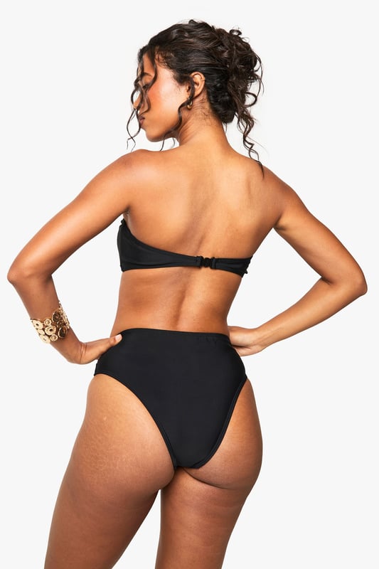 Bandeau-style bikini top with eye-catching gold-tone hardware
        High-waisted bottoms for a flattering silhouette
        Textured fabric adds visual interest and depth
        Strapless design perfect for minimising tan lines
        Versatile two-piece suitable for various beach activities
    
    Make waves this summer in this striking bandeau bikini set from Boohoo. The strapless top features a bold gold-tone accent, adding a touch of glamour to your beach ensemble. Paired with high-waisted bottoms, this swimwear set offers both style and comfort for your seaside adventures. The textured fabric adds a luxurious feel, while the classic design ensures you'll stand out whether you're lounging by the pool or taking a dip in the sea. Accessorise with oversized sunglasses and a wide-brimmed hat for the ultimate resort look. Perfect for your next sunny getaway or a day at the local lido, this bikini set is a must-have addition to your summer wardrobe. Its versatile design allows for easy mixing and matching with other swimwear pieces, giving you multiple styling options throughout the season.