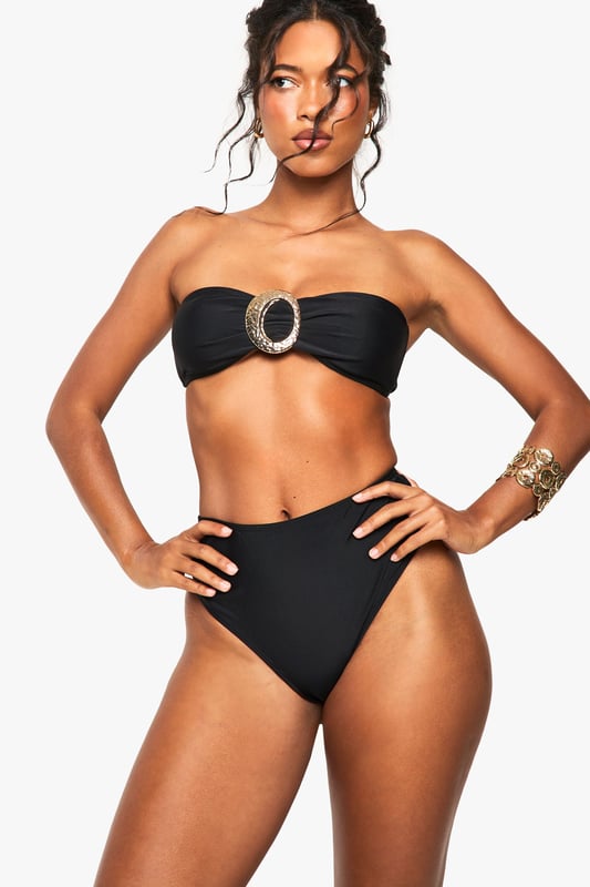 Bandeau-style bikini top with eye-catching gold-tone hardware
        High-waisted bottoms for a flattering silhouette
        Textured fabric adds visual interest and depth
        Strapless design perfect for minimising tan lines
        Versatile two-piece suitable for various beach activities
    
    Make waves this summer in this striking bandeau bikini set from Boohoo. The strapless top features a bold gold-tone accent, adding a touch of glamour to your beach ensemble. Paired with high-waisted bottoms, this swimwear set offers both style and comfort for your seaside adventures. The textured fabric adds a luxurious feel, while the classic design ensures you'll stand out whether you're lounging by the pool or taking a dip in the sea. Accessorise with oversized sunglasses and a wide-brimmed hat for the ultimate resort look. Perfect for your next sunny getaway or a day at the local lido, this bikini set is a must-have addition to your summer wardrobe. Its versatile design allows for easy mixing and matching with other swimwear pieces, giving you multiple styling options throughout the season.