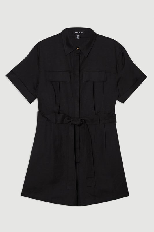 This Karen Millen playsuit combines effortless style with practical design for versatile daywear. The woven viscose linen fabric offers a natural texture and comfortable feel, perfect for warmer days. The belted waist creates a feminine shape while the collared neckline maintains a smart edge. Layer with a lightweight cardigan when the temperature drops, or add a crossbody bag for hands-free convenience during city explorations. This playsuit transitions seamlessly from shopping trips to alfresco dining, making it an essential addition to your warm-weather wardrobe.  Crafted from a viscose linen blend Classic collared neckline with button-through front design Short sleeves with neat cuffs Practical chest pockets Matching fabric belt