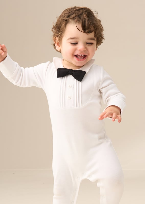 Our smart new onesie is the perfect blend of style and comfort for your little gentleman. Made from soft. breathable jersey. this all-in-one will keep them comfy while looking oh-so-smart. The crisp design is finished with a classic bow tie. while fuss-free poppers make for easy changes. Special occasion or just because - this one’s a charmer!.