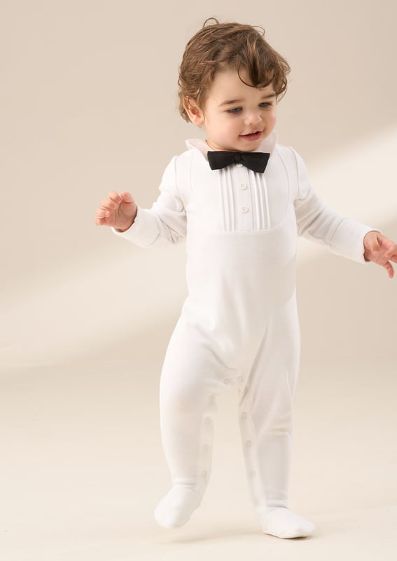 Our smart new onesie is the perfect blend of style and comfort for your little gentleman. Made from soft. breathable jersey. this all-in-one will keep them comfy while looking oh-so-smart. The crisp design is finished with a classic bow tie. while fuss-free poppers make for easy changes. Special occasion or just because - this one’s a charmer!.