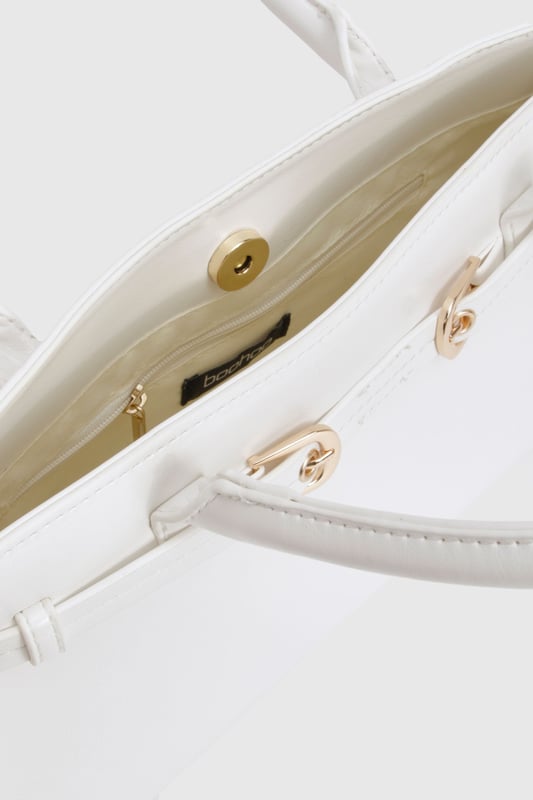 Structured design with elegant gold-tone buckle detailing
        Spacious interior with secure magnetic closure
        Versatile top handles for comfortable carrying
        Sleek rectangular silhouette perfect for day-to-night transition
        Durable construction with clean lines and minimal hardware
    
    This structured handbag combines sophistication with practicality for your nights out. The clean, architectural shape creates a polished look whilst the gold-tone buckle adds a touch of glamour without overwhelming your outfit. Style with a crisp button-up and tailored trousers for drinks after work, or pair with your favourite bodycon dress when heading to the club. The versatile design works brilliantly with both monochrome ensembles and bold prints, making it your go-to accessory for urban nightlife. With enough room for your essentials yet compact enough to carry comfortably all night, this Boohoo bag strikes the perfect balance between fashion and function. The timeless design ensures it will remain a staple in your collection for countless nights out.
