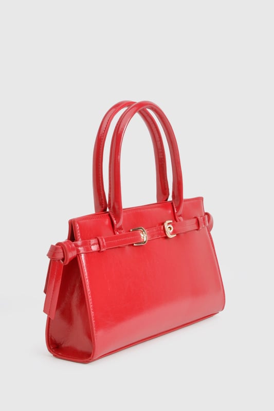 Structured design with elegant buckle detail and gold-tone hardware
        Sleek top handle for sophisticated hand-carry option
        High-shine finish for a statement look
        Spacious interior with zip pocket for secure storage
        Adjustable side buckles for customisable shape
    
    This structured handbag combines practicality with urban chic, perfect for elevating your night-out ensemble. The distinctive buckle detail and glossy finish create a bold statement piece that commands attention, whilst the compact yet roomy interior offers ample space for your evening essentials. Style with contrasting casual pieces like distressed denim and a graphic top for an effortlessly cool look, or pair with a sleek bodycon dress and strappy heels for a more polished club appearance. The versatile size makes it ideal for drinks with friends or dancing the night away, whilst the secure fastening ensures your belongings stay safe throughout your adventures. A true Boohoo staple that transitions seamlessly from early evening cocktails to late-night revelry.