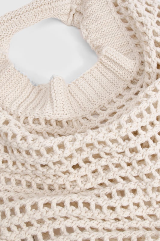 Distinctive crochet design with an open-weave pattern for a bohemian aesthetic
        Spacious interior perfect for carrying daily essentials
        Comfortable shoulder strap with reinforced edges for durability
        Rounded silhouette creates a relaxed, slouchy appearance
        Versatile design that complements both daytime and evening casual outfits
    
    This charming crochet shoulder bag brings a touch of artisanal flair to your everyday ensemble. The intricate open-weave pattern creates a delightful textural contrast against smooth fabrics, making it an eye-catching accessory for the fashion-forward woman. Style with a flowing midi dress and sandals for farmers' markets and seaside strolls, or pair with denim shorts and a simple tee for festival outings. The bag's generous capacity accommodates your phone, wallet, and beauty essentials without compromising on style. For cooler days, this bag works brilliantly with a casual jumper and straight-leg trousers. The neutral tone ensures it will coordinate seamlessly with your existing wardrobe, making it a versatile companion for casual gatherings and weekend brunches throughout the seasons.