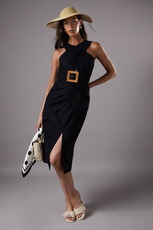 Lisa Tan Polo Cross Neck Belted Dress Distinctive cross-neck design creates an elegant silhouette
Statement square buckle belt detail accentuates the waist
Sophisticated side split adds movement and allure
Linen-blend fabric offers breathable comfort with structure
Midi length provides versatile styling options for various occasions
The Lisa Polo Cross Neck Belted Dress from Coast embodies refined elegance with its architectural neckline and striking belt detail. The cross-neck design frames the dcolletage beautifully, while the structured silhouette with a side split creates a graceful movement as you walk. Perfect for summer race days or garden weddings, this dress commands attention without overwhelming. Style with a wide-brimmed hat and delicate strappy sandals as shown for a quintessentially British summer event look. For evening soires, swap the hat for statement earrings and add metallic heeled sandals. The versatile midi length works wonderfully for both daytime formality and evening sophistication, making this a standout piece for your occasion wardrobe that transitions effortlessly from day to night.