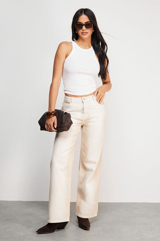 Relaxed dad jean silhouette with a contemporary ombre effect
        Wide-leg design offering maximum comfort and movement
        Classic five-pocket styling with traditional denim detailing
        High-rise waistband for a flattering and secure fit
        Crafted from 100% cotton for breathable, durable wear
    
    These Warehouse Ombre Denim Dad Jeans reflect the brand's confident, feminine aesthetic whilst delivering on everyday comfort. The relaxed silhouette creates an effortlessly cool vibe that works brilliantly with fitted tops to balance proportions. Style as seen with a simple crop top and western boots for an edgy daytime look, or dress up with a tucked-in silk blouse and statement jewellery for casual gatherings. The versatile ecru shade offers a fresh alternative to traditional denim, making these jeans perfect for spring through autumn wardrobes. Their relaxed fit allows for easy layering during cooler months - try with an oversized knit and trainers for weekend brunches or family gatherings. Machine washable for practical, fuss-free care.