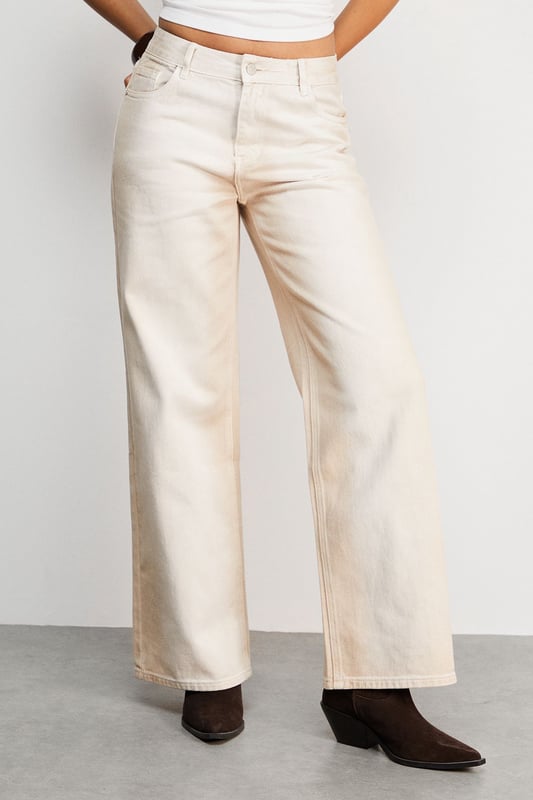 Relaxed dad jean silhouette with a contemporary ombre effect
        Wide-leg design offering maximum comfort and movement
        Classic five-pocket styling with traditional denim detailing
        High-rise waistband for a flattering and secure fit
        Crafted from 100% cotton for breathable, durable wear
    
    These Warehouse Ombre Denim Dad Jeans reflect the brand's confident, feminine aesthetic whilst delivering on everyday comfort. The relaxed silhouette creates an effortlessly cool vibe that works brilliantly with fitted tops to balance proportions. Style as seen with a simple crop top and western boots for an edgy daytime look, or dress up with a tucked-in silk blouse and statement jewellery for casual gatherings. The versatile ecru shade offers a fresh alternative to traditional denim, making these jeans perfect for spring through autumn wardrobes. Their relaxed fit allows for easy layering during cooler months - try with an oversized knit and trainers for weekend brunches or family gatherings. Machine washable for practical, fuss-free care.