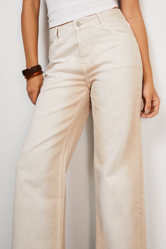 Relaxed dad jean silhouette with a contemporary ombre effect
        Wide-leg design offering maximum comfort and movement
        Classic five-pocket styling with traditional denim detailing
        High-rise waistband for a flattering and secure fit
        Crafted from 100% cotton for breathable, durable wear
    
    These Warehouse Ombre Denim Dad Jeans reflect the brand's confident, feminine aesthetic whilst delivering on everyday comfort. The relaxed silhouette creates an effortlessly cool vibe that works brilliantly with fitted tops to balance proportions. Style as seen with a simple crop top and western boots for an edgy daytime look, or dress up with a tucked-in silk blouse and statement jewellery for casual gatherings. The versatile ecru shade offers a fresh alternative to traditional denim, making these jeans perfect for spring through autumn wardrobes. Their relaxed fit allows for easy layering during cooler months - try with an oversized knit and trainers for weekend brunches or family gatherings. Machine washable for practical, fuss-free care.
