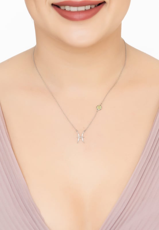 Zodiac Birthstone Pisces Necklace Aqua Chalcedony Silver Dive into the depths of Pisces mystical realm with the Zodiac Pisces Birthstone Necklace Aqua Chalcedony Silver. Pisceans celebrate their birthday Feb 19- Mar 20.This zodiac necklace features the fishes' constellation set with sparkling cubic zirconia highlights, complemented by a serene lab-created Aqua Chalcedony set along the 40-45cm chain.Crafted in 925 sterling silver, this piece embodies the fish's intuitive and compassionate spirit, with Aqua Chalcedony bringing calm and reflection, perfect for navigating the emotional waters of the horoscope.