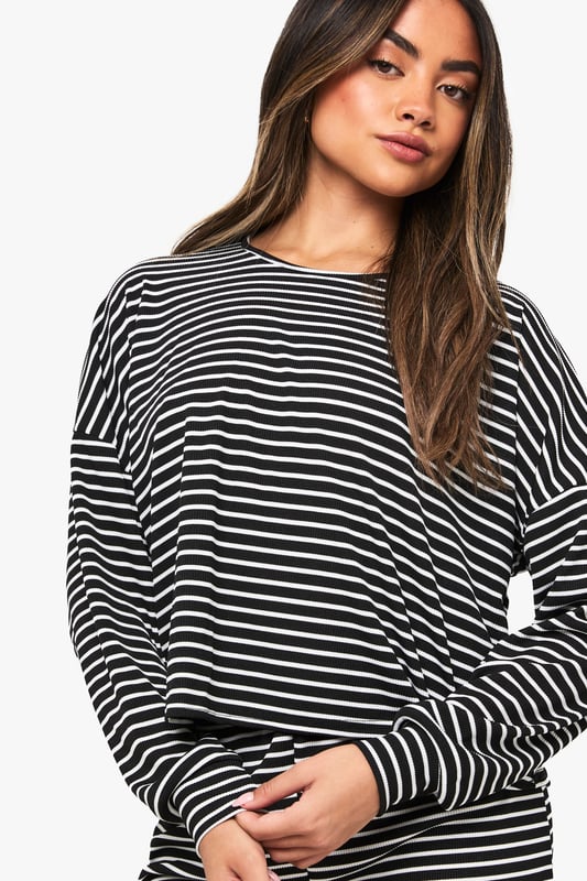 Loungewear Stripe Long Sleeve Top & Shorts Pyjama Set Relaxed fit long-sleeved jersey top with classic horizontal stripe pattern
Dropped shoulder design for effortless comfort and contemporary silhouette
Matching shorts with comfortable elastic waistband for ease of movement
Soft knitted jersey fabric that's gentle against the skin
Versatile two-piece set that can be worn together or styled separately
Embrace laid-back luxury with this striped jersey co-ord set from Boohoo. The oversized long-sleeved top features a relaxed fit with dropped shoulders that creates an effortlessly chic silhouette, whilst the matching shorts offer the perfect balance of comfort and style. Perfect for those cosy nights in when you still want to look put-together, this set is ideal for lounging, weekend brunches at home, or casual film nights with friends. Style with fluffy socks and your favourite oversized cardigan when temperatures drop, or wear the pieces separately to maximise your wardrobe options. The timeless stripe pattern ensures this set will remain a staple in your loungewear collection for seasons to come, whilst the soft knitted fabric provides that much-needed comfort for your downtime moments.