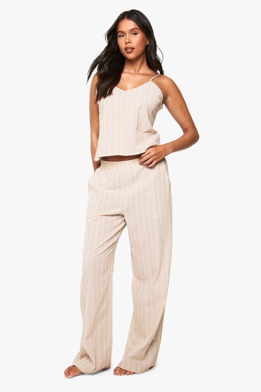 Soft cotton pyjama set featuring classic pinstripe pattern throughout
        Relaxed cami top with delicate adjustable straps and flattering V-neckline
        Wide-leg trousers with comfortable elasticated waistband for ease of movement
        Two-piece design allows for mix-and-match styling options
        Lightweight fabric ensures breathability for a comfortable night's sleep
    
    Drift into dreamland in style with this chic cotton pinstripe pyjama set from Boohoo. The relaxed silhouette combines comfort with contemporary design, making bedtime a fashionable affair. The cami top features a flattering V-neckline that creates an elegant look, whilst the wide-leg trousers offer unrestricted movement for a peaceful night's rest. Perfect for lounging at home on lazy weekend mornings or for packing on your next weekend getaway. For cooler evenings, simply layer with a soft dressing gown or oversized cardigan. This versatile set transitions effortlessly from night to morning, allowing you to enjoy your first cup of tea in comfort without compromising on style. The timeless pinstripe pattern adds a touch of sophistication to your nightwear collection.