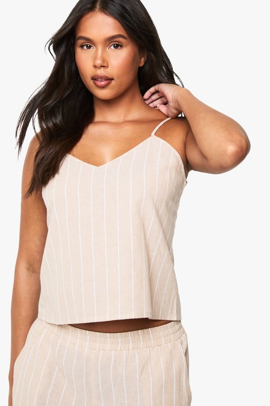 Soft cotton pyjama set featuring classic pinstripe pattern throughout
        Relaxed cami top with delicate adjustable straps and flattering V-neckline
        Wide-leg trousers with comfortable elasticated waistband for ease of movement
        Two-piece design allows for mix-and-match styling options
        Lightweight fabric ensures breathability for a comfortable night's sleep
    
    Drift into dreamland in style with this chic cotton pinstripe pyjama set from Boohoo. The relaxed silhouette combines comfort with contemporary design, making bedtime a fashionable affair. The cami top features a flattering V-neckline that creates an elegant look, whilst the wide-leg trousers offer unrestricted movement for a peaceful night's rest. Perfect for lounging at home on lazy weekend mornings or for packing on your next weekend getaway. For cooler evenings, simply layer with a soft dressing gown or oversized cardigan. This versatile set transitions effortlessly from night to morning, allowing you to enjoy your first cup of tea in comfort without compromising on style. The timeless pinstripe pattern adds a touch of sophistication to your nightwear collection.