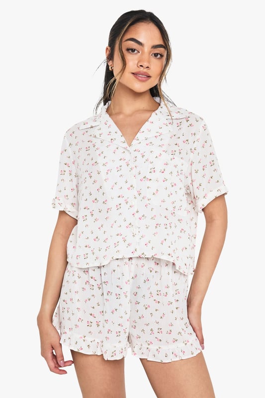 Floral Print Cheesecloth Short Sleeve Shirt & Shorts Pyjama Set Charming floral print short pyjama set with classic collared shirt design
Relaxed boxy fit shirt with short sleeves for ultimate comfort
V-neck collar adds a touch of sophistication to your nightwear collection
Matching shorts with gentle elastic waistband for a comfortable fit
Lightweight woven fabric perfect for year-round wear
Drift into dreamland in style with this delightful floral pyjama set from boohoo. The boxy shirt silhouette offers a relaxed feel that doesn't compromise on style, whilst the matching shorts create a coordinated look that's both practical and pretty. Perfect for warm summer nights or cosy evenings with a dressing gown layered on top during cooler months. The versatile design makes this set ideal for lounging at home with friends during sleepovers or enjoying a lazy weekend morning with a cup of tea. Style with fluffy slippers and your favourite hair accessories, just as shown on our model, for the ultimate night-in ensemble that combines comfort with a touch of feminine charm.