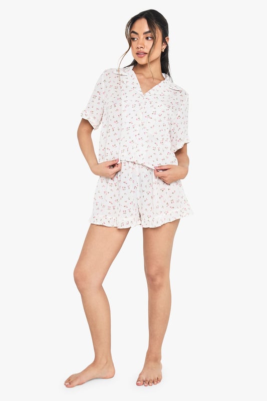 Floral Print Cheesecloth Short Sleeve Shirt & Shorts Pyjama Set Charming floral print short pyjama set with classic collared shirt design
Relaxed boxy fit shirt with short sleeves for ultimate comfort
V-neck collar adds a touch of sophistication to your nightwear collection
Matching shorts with gentle elastic waistband for a comfortable fit
Lightweight woven fabric perfect for year-round wear
Drift into dreamland in style with this delightful floral pyjama set from boohoo. The boxy shirt silhouette offers a relaxed feel that doesn't compromise on style, whilst the matching shorts create a coordinated look that's both practical and pretty. Perfect for warm summer nights or cosy evenings with a dressing gown layered on top during cooler months. The versatile design makes this set ideal for lounging at home with friends during sleepovers or enjoying a lazy weekend morning with a cup of tea. Style with fluffy slippers and your favourite hair accessories, just as shown on our model, for the ultimate night-in ensemble that combines comfort with a touch of feminine charm.
