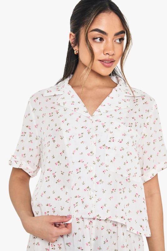 Floral Print Cheesecloth Short Sleeve Shirt & Shorts Pyjama Set Charming floral print short pyjama set with classic collared shirt design
Relaxed boxy fit shirt with short sleeves for ultimate comfort
V-neck collar adds a touch of sophistication to your nightwear collection
Matching shorts with gentle elastic waistband for a comfortable fit
Lightweight woven fabric perfect for year-round wear
Drift into dreamland in style with this delightful floral pyjama set from boohoo. The boxy shirt silhouette offers a relaxed feel that doesn't compromise on style, whilst the matching shorts create a coordinated look that's both practical and pretty. Perfect for warm summer nights or cosy evenings with a dressing gown layered on top during cooler months. The versatile design makes this set ideal for lounging at home with friends during sleepovers or enjoying a lazy weekend morning with a cup of tea. Style with fluffy slippers and your favourite hair accessories, just as shown on our model, for the ultimate night-in ensemble that combines comfort with a touch of feminine charm.