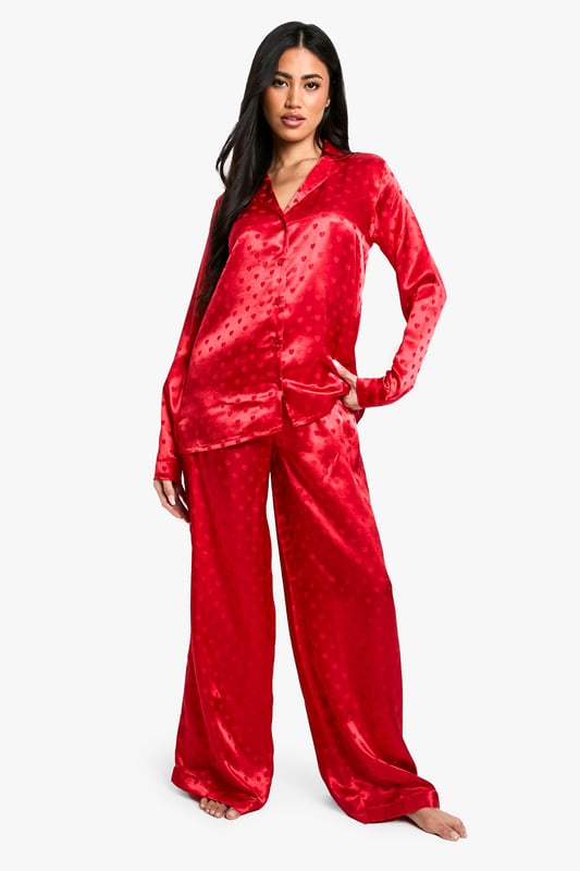 Satin Heart Jacquard Shirt & Trouser Pyjama Set Luxurious satin fabric with charming heart-print jacquard pattern
Relaxed fit shirt with classic collar and button-down front
Long sleeves for cosy comfort
Wide-leg trousers with elasticated waistband for ease of movement
Versatile two-piece set perfect for lounging or sleeping
Indulge in the ultimate night-time luxury with this stunning satin jacquard shirt and trouser set. The alluring heart-print pattern adds a touch of romance to your bedtime routine, while the soft, smooth fabric gently caresses your skin for a truly comfortable sleep. The relaxed fit of both pieces ensures unrestricted movement, whether you're curling up with a good book or catching some well-deserved shut-eye. Style this set with cosy slippers and a plush dressing gown for those chilly evenings, or wear it on its own during warmer nights. Perfect for lazy weekend mornings or impromptu video calls with friends, this versatile pyjama set effortlessly combines style and comfort. Make bedtime your most fashionable hour with this must-have addition to your nightwear collection.
