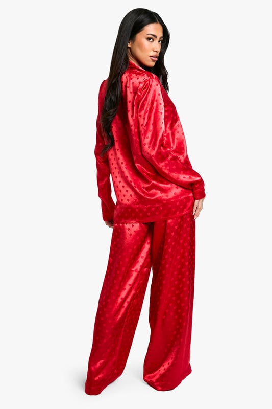 Satin Heart Jacquard Shirt & Trouser Pyjama Set Luxurious satin fabric with charming heart-print jacquard pattern
Relaxed fit shirt with classic collar and button-down front
Long sleeves for cosy comfort
Wide-leg trousers with elasticated waistband for ease of movement
Versatile two-piece set perfect for lounging or sleeping
Indulge in the ultimate night-time luxury with this stunning satin jacquard shirt and trouser set. The alluring heart-print pattern adds a touch of romance to your bedtime routine, while the soft, smooth fabric gently caresses your skin for a truly comfortable sleep. The relaxed fit of both pieces ensures unrestricted movement, whether you're curling up with a good book or catching some well-deserved shut-eye. Style this set with cosy slippers and a plush dressing gown for those chilly evenings, or wear it on its own during warmer nights. Perfect for lazy weekend mornings or impromptu video calls with friends, this versatile pyjama set effortlessly combines style and comfort. Make bedtime your most fashionable hour with this must-have addition to your nightwear collection.